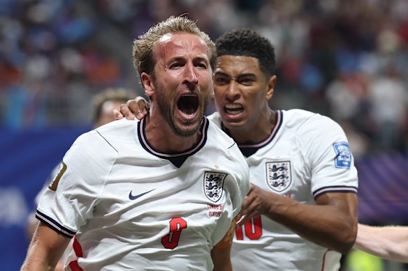 Harry Kane of England celebrates with teammate Jude Bellingham after finding an equaliser.