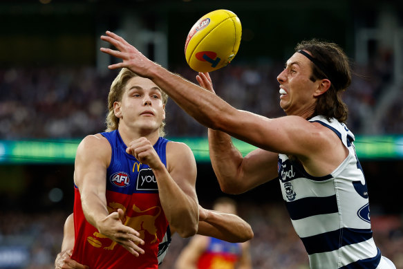Will Ashcroft of the Lions and Jack Henry of the Cats compete for the ball.