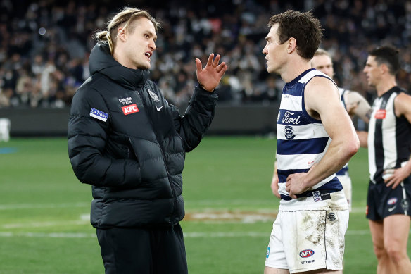 Darcy Moore and Jeremy Cameron in conversation after the Magpies’ win over the Cats.