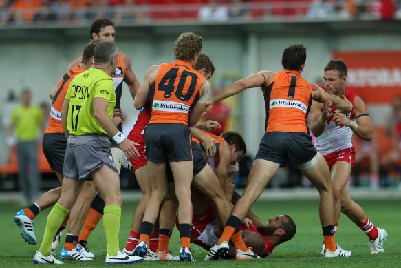Toby Greene and Lance Franklin (both on ground) during a spiteful Sydney derby in 2014.