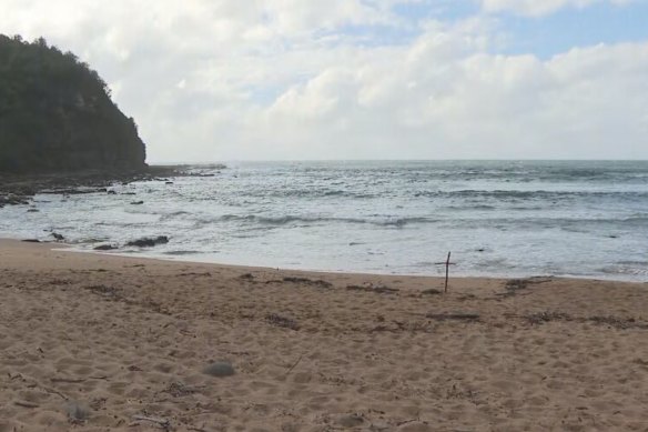 The men were fishing from a rock platform at Little Beach in Bouddi National Park.