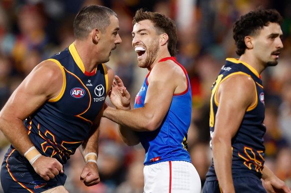 Footy’s a laugh: Adelaide’s Taylor Walker and Demon Jack Viney.