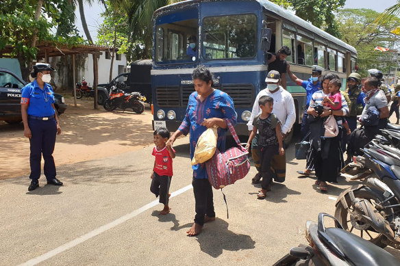 Sri Lankan police bring ashore a group of people who were attempting to travel to Australia on another boat before the election.