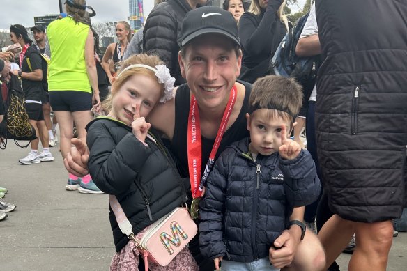 Horse trainer Mitchell Freedman with children Meg and George after the Melbourne Marathon.