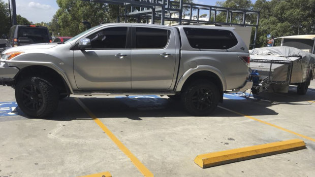 A ute with a trailer parked illegally across four disabled parking spaces earlier this month. 