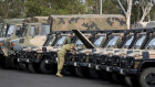Army reservists at Holsworthy Army Barracks in south-west Sydney on Sunday prepare for deployment to the fire front. 