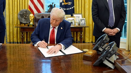 Donald Trump signs an executive order. 