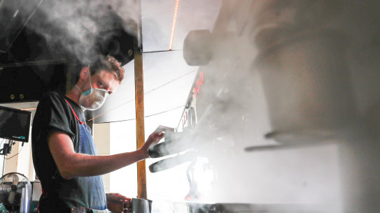 Steamy and smoke: barista Alex Cooper at work on the GPO Building porch. 