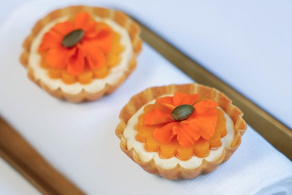 Tartella de zucca, a tartlet holding parmesan custard, confit pumpkin and pumpkin seed praline.
