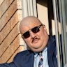 Simeon Boikov waves from the Russian consulate in Sydney in April 2023. He remains in a self-imposed exile after breaching the suppression on Rosentool’s name, and assaulting a Ukraine supporter.