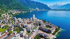 a high-angle aerial perspective of Montreux, a picturesque resort town located along the eastern shore of Lake Geneva in Switzerland. 