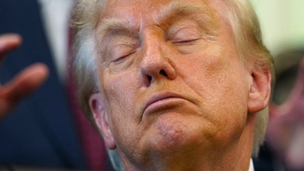 Donald Trump appearing to nap during an Oval Office event.