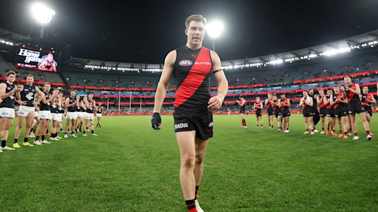 Zach Merrett of the Bombers walks off the ground following his 250th game.
