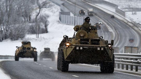 A convoy of Russian armoured vehicles moves along a highway in Crimea this month. 