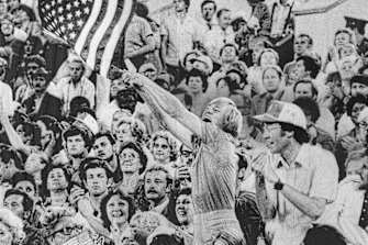 A spectator waves the American flag at the closing ceremony Lenin Stadium on August 3, 1980. 