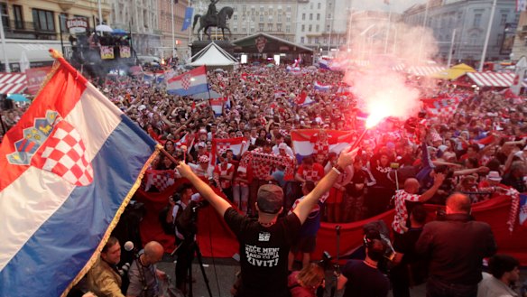 National fervour: Croatian fans watch their team win the semi-final against England in Zagreb.