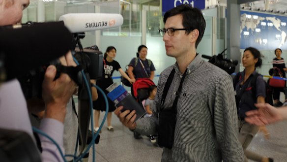 Australian student Alek Sigley goes through a security check at Beijing International airport on Thursday afternoon. 