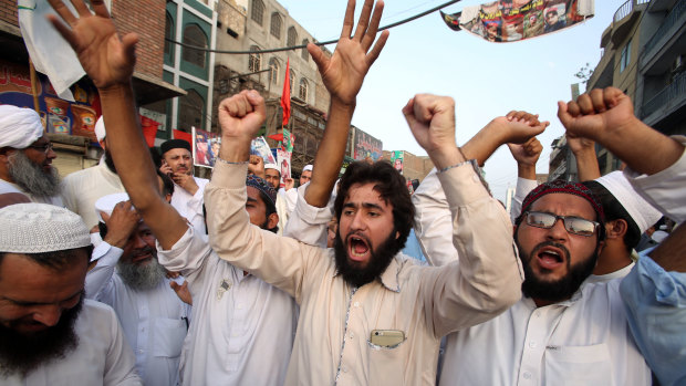 Supporters of different political parties demonstrate to reject the election results in Peshawar, Pakistan, on Friday.
