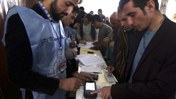 Local residents use their fingerprints to register to vote in the parliamentary elections in Kabul, Afghanistan in October.