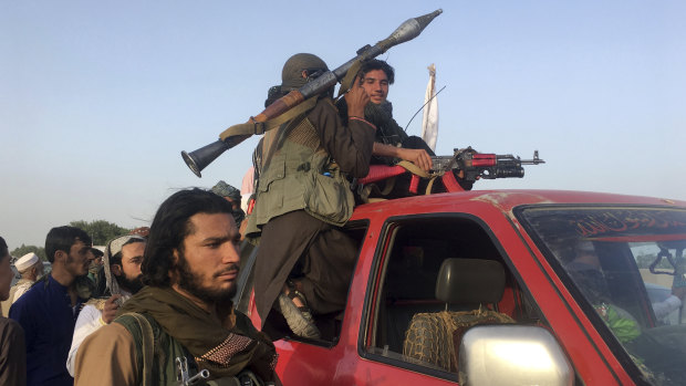 Taliban fighters ride in their vehicle in Surkhroad district of Nangarhar province, east of Kabul, Afghanistan, on Saturday.