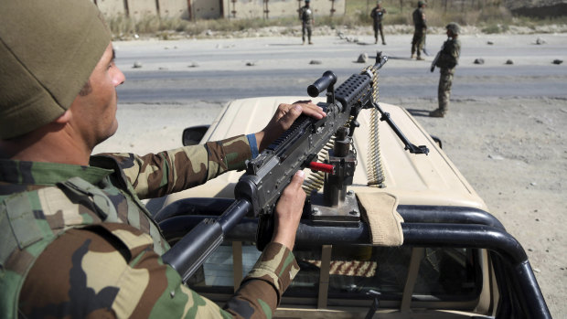 Afghan National Army soldiers patrol a checkpoint in Kabul.
