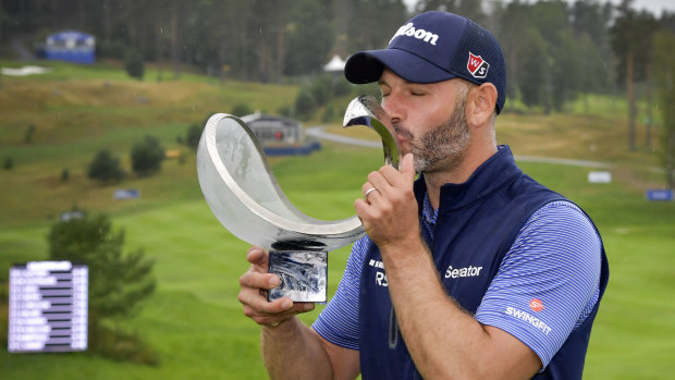 At long last: Paul Waring kisses the trophy after winning the Nordea Masters in Sweden.
