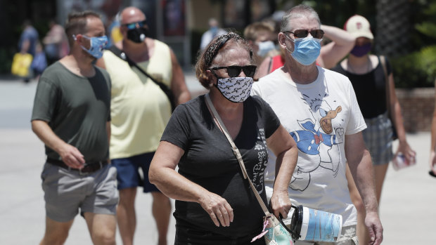 People wearing face masks at a shopping centre in Florida, where coronavirus cases have spiked.