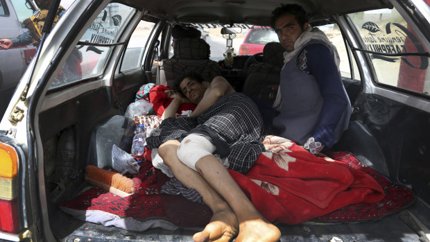 An injured man is transported on the Ghazni highway, in Maidan Shar, west of Kabul, Afghanistan.