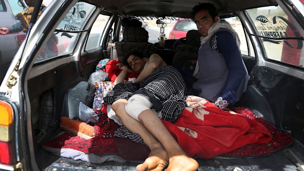 An injured man is transported on the Ghazni highway, in Maidan Shar, west of Kabul, Afghanistan.