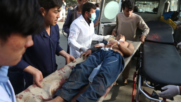 A male is treated after a classroom of students was hit in the Shiite neighbourhood of Dasht-i Barcha.