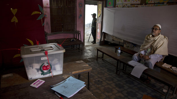 A polling official waits for voters at a polling station in the ancient city of Panam Nagar, about 20 kilometres south-east of Dhaka.