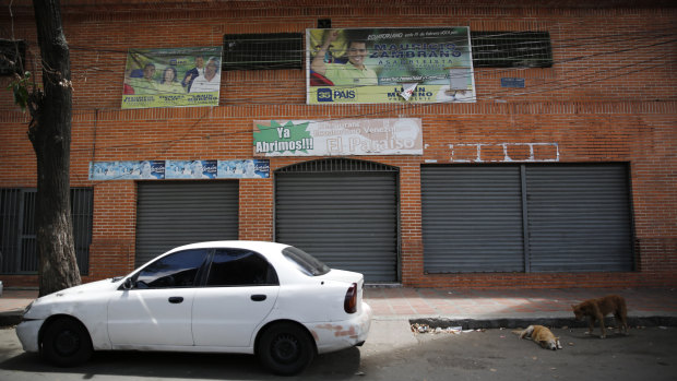 A car is parked in front of "Los Cotorros" club at the neighbourhood of El Paraiso, in Caracas, Venezuela, on Saturday.