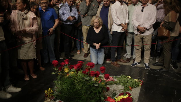 People visit the tomb of former Spanish dictator Francisco Franco inside the basilica at the Valley of the Fallen monument near El Escorial, outside Madrid. 