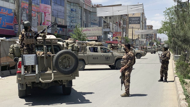 Afghan security personnel arrive at the site where the gunmen attacked.