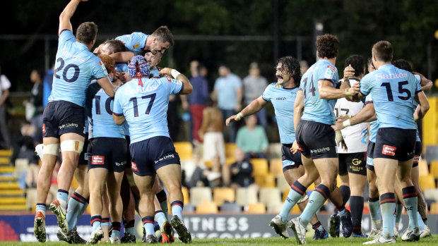 The Waratahs celebrate at full-time after knocking off the Crusaders at Leichhardt Oval.