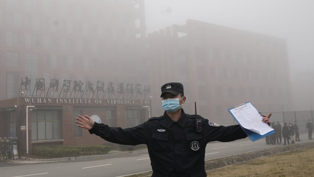 A security person moves journalists away from the Wuhan Institute of Virology after a World Health Organisation team arrived for a field visit in Wuhan in China’s Hubei province. 