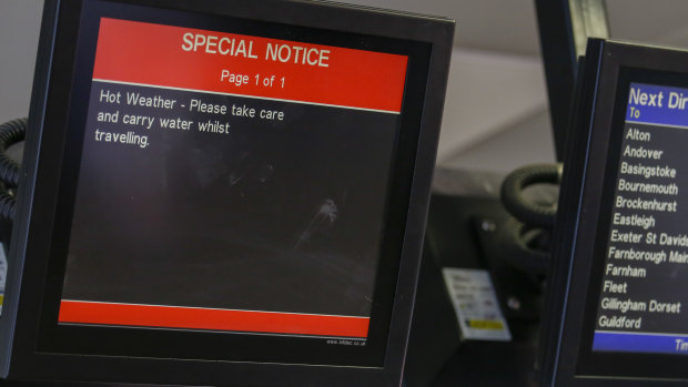 An information screen warns commuters of hot weather at Clapham Junction in London on Thursday.