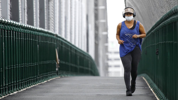 A jogger on the Story Bridge wearing a mask on Saturday, January 9.