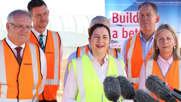 Queensland Premier Annastacia Palaszczuk (centre) talks with Australian Prime Minister Scott Morrison (left) and Minister for Agriculture Bridget McKenzie (right) at a construction site in the suburb of Rochedale, in Brisbane where details of new infrastructure funding was announced on Wednesday.