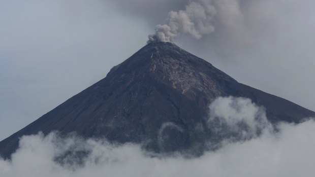 A plume of smoke and ash rise from the Volcano of Fire as seen from San Miguel Los Lotes, Guatemala, in June.