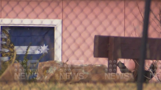 Footage showing the woman surrendering out the front of the home in Bowenfels on Monday morning.