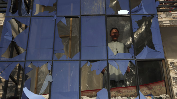 An Afghan boy looks out from a broken window after a bomb explosion in Kabul in February.