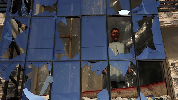 An Afghan boy looks out from a broken window after a bomb explosion in Kabul in February.