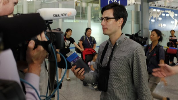 Australian student Alek Sigley goes through a security check at Beijing International airport on Thursday afternoon. 