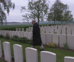 John Howard views graves at Tincourt-Boucly on the Western Front in April 2000.