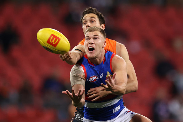 Robbie McComb and Josh Kelly battle for the ball.