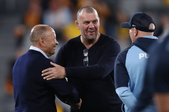 Argentina coach Michael Cheika shakes hands with Wallabies coach Eddie Jones.