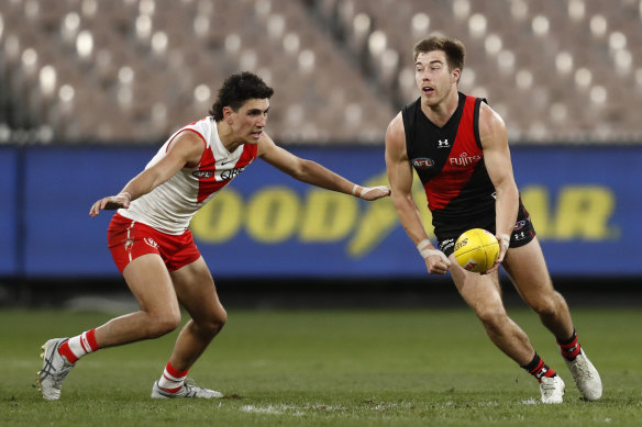 Zach Merrett looks to get the ball away against the Swans.