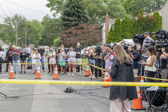Reporters are seen outside the Heuermann home.