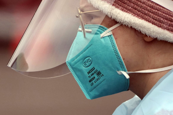 A medical worker in an N95 mask.